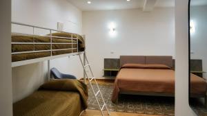a room with two bunk beds and a couch at Al Duomo Suites in Monreale