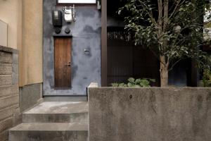 a front door of a house with a tree at Nozomu House Kyoto in Kyoto