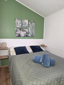 a bedroom with a bed with two pillows on it at Apartamenty Boszkowo Lakeside in Boszkowo