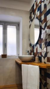 a bathroom with a sink and a mirror at Al Duomo Suites in Monreale