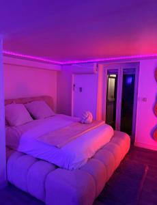 a bedroom with two beds and a purple ceiling at L'Interdite House - Limitless - Jacuzzi Cinema Love in Savigny-sur-Orge