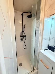 a shower with a shower head in a bathroom at L'Interdite House - Limitless - Jacuzzi Cinema Love in Savigny-sur-Orge +5 photos