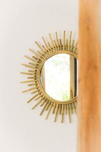 a gold mirror on a wall next to a window at Naïa Ocean House Midigama in Midigama West