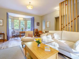 a living room with a couch and a table at East Lodge in Falkland