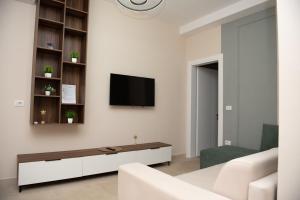 a living room with a tv on a wall at White Arena Apartments GOLEM in Golem