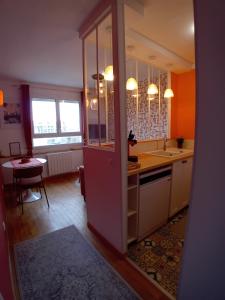 a kitchen with a sink and a counter top at La parenthèse 70's in Le Havre +24 photos