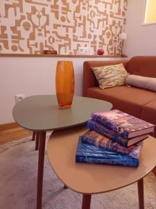 a table with books and a vase on top at La parenthèse 70's in Le Havre