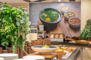 a restaurant with dishes on the wall of a buffet at CHECK inn Taichung Ziyou in Taichung