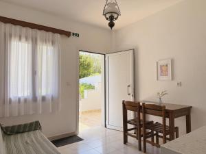 a dining room with a table and two chairs at Xenius Zeus Apartments in Kriopigi in Kriopigi