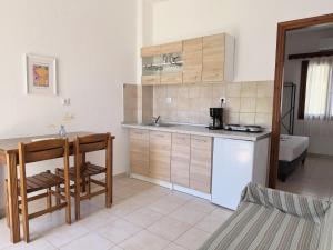 a kitchen with a sink and a table and a counter at Xenius Zeus Apartments in Kriopigi in Kriopigi +26 photos