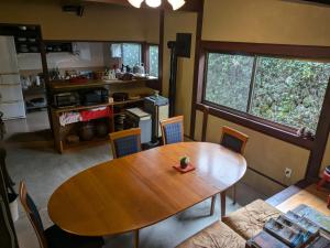 a dining room with a table and a couch at 古民家のこのこ in Tanabe