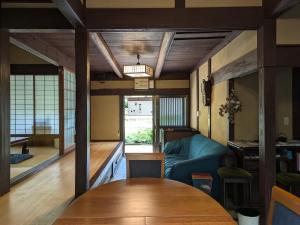 a living room with a couch and a table at 古民家のこのこ in Tanabe
