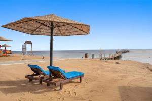 two blue chairs and an umbrella on a beach at Pickalbatros Sands Port Ghalib in Port Ghalib +136 photos
