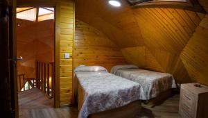 a bedroom with two beds in a wooden cabin at Camping Las Nogueras de Nerpio in Nerpio +50 photos