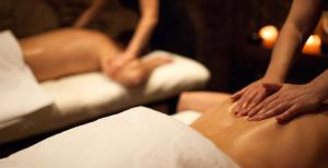 two people are getting their hands on a persons stomach at Casa Vacanze Borc dai Cucs in Faedis