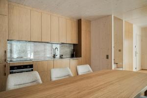 a kitchen with a large wooden table and chairs at Borderlake One in Ruka