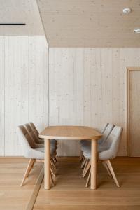 a dining room with a wooden table and chairs at Borderlake One in Ruka +7 photos
