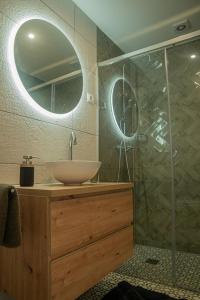 a bathroom with a sink and a shower with a mirror at Cortijo el Sendero in Alora +42 photos