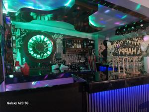 a bar with a dart board on the wall at Buddy's Skybar & Suite in Guinsorongan