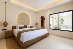 a bedroom with a large bed and a large window at Solaya Villas Canggu in Canggu +42 photos