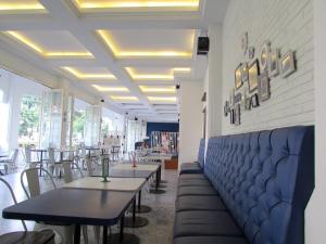 a row of tables and chairs in a restaurant at Riche Heritage Hotel in Malang