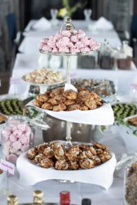 a table with three tiered plates of cookies and pastries at Wiks Slott in Vik