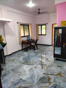 a living room with a marble floor and a desk at Tree hugs mandrem in Mandrem +1 photo