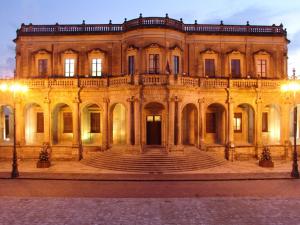 a large building with stairs in front of it at Nonna Pia in Noto