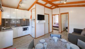 a kitchen and living room with a table in a room at Macquarie Caravan Park in Warren +16 photos