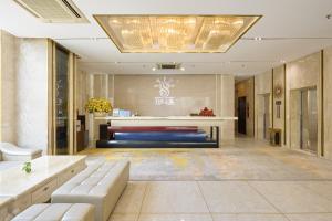 a lobby with a couch and a table in a room at The Sol Hotel in Nha Trang +58 photos