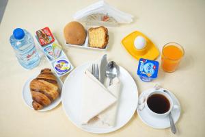a table with plates of food and a cup of coffee at Hotel karim Tunis in Tunis