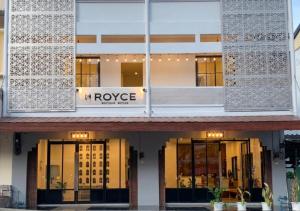 a building with glass doors and a sign on it at Royce Boutique Betong in Betong
