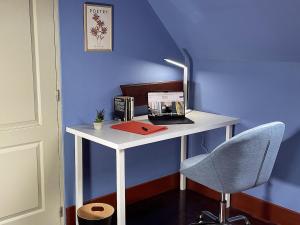 a white desk with a computer and a chair at Jolie chambre sous les toits in Dreux