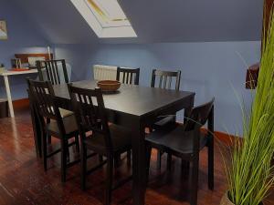 a dining room table with chairs and a table and a table and chairsktop at Jolie chambre sous les toits in Dreux