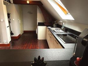 a kitchen with a sink and a stove in it at Jolie chambre sous les toits in Dreux