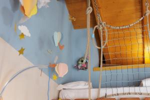 a childs bedroom with a swing in a room at B&B La barca ant al prà in Cuneo +42 photos