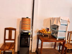 a kitchen with a blender and a table with chairs at Nongkhiew Heaven Backpackers Hostel & Tours in Nongkhiaw +18 photos