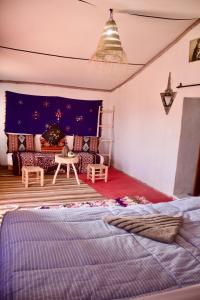 a living room with a bed and a couch at Camp Ayour Mhamid in Mhamid