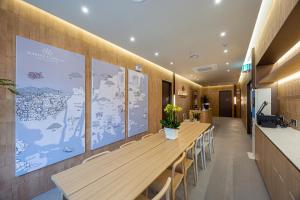 a conference room with a long wooden table and chairs at Haeundae Marine Capsule Hotel&Spa in Busan