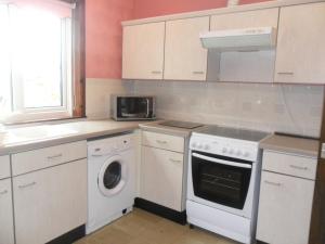 a kitchen with a washer and dryer in it at Ken Maree in South Erradale