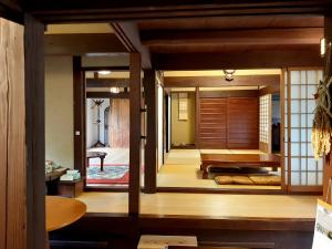 a japanese room with a door leading to a bedroom at 古民家のこのこ in Tanabe +34 photos