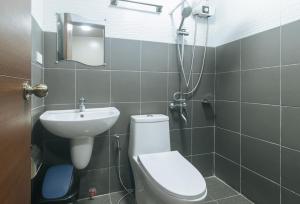 a bathroom with a toilet and a sink at Algers Suites Bayan-Bayanan Marikina City in Manila +50 photos