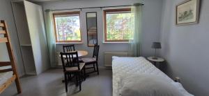 a bedroom with a bed and a table and chairs at Kalkbrottets Vandrarhem in Slite