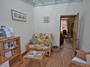 a living room with a couch and a table at Cosy Cottage in Warkworth