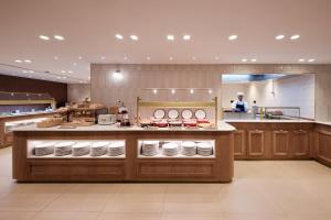 a kitchen with a counter with a person in the background at Catalonia Eixample 1864 in Barcelona