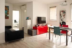 a living room with a table and a red cabinet at Art-inn in San Vendemiano
