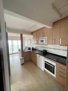 a kitchen with a sink and a stove top oven at Pineda Beach PORT AVENTURA in La Pineda