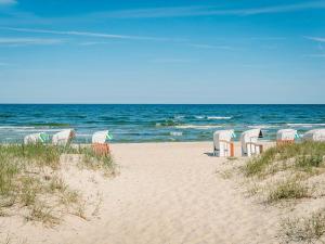 a group of chairs sitting on the beach at Fährhaus Sellin - Ferienwohnung 2 in Ostseebad Sellin
