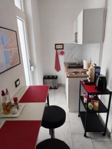 a kitchen with a counter and a red counter top at Ca' de' Mari at Como - Switzerland - Private Parking - Self Check-In in Faloppio