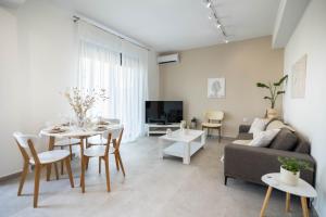a living room with a table and a couch at Maison Poème Luxury Apartments in Aiándion